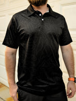 Black motorsports polo shirt featuring an all-over, minimalist pattern of racetrack layouts.
